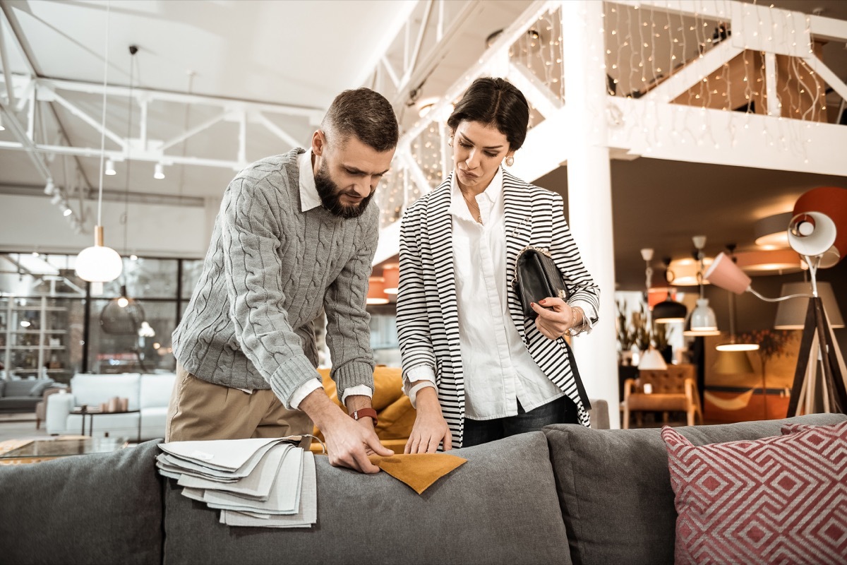 couple picking out furniture fabric cover samples