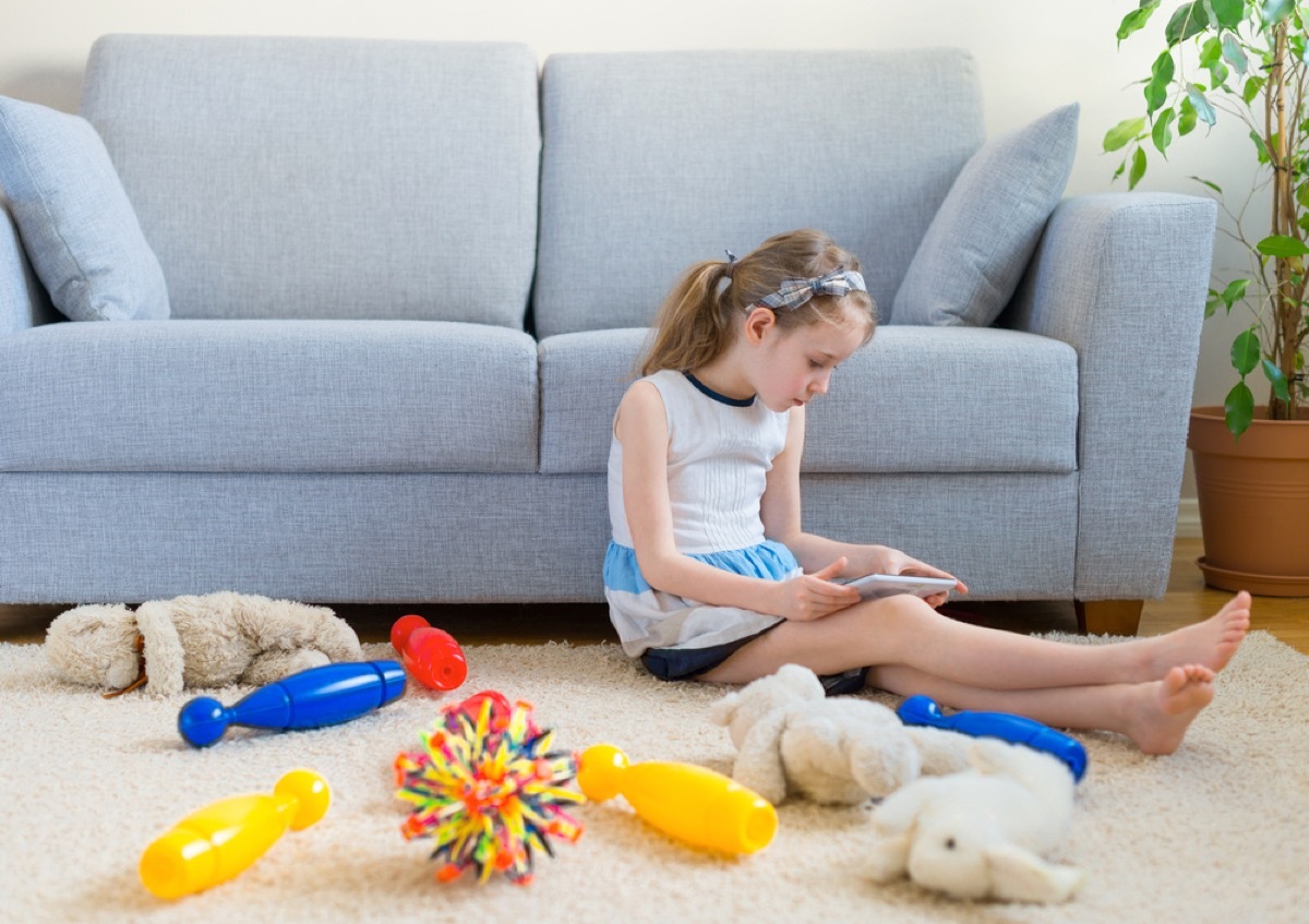 girl in playroom with toys, stay at home mom