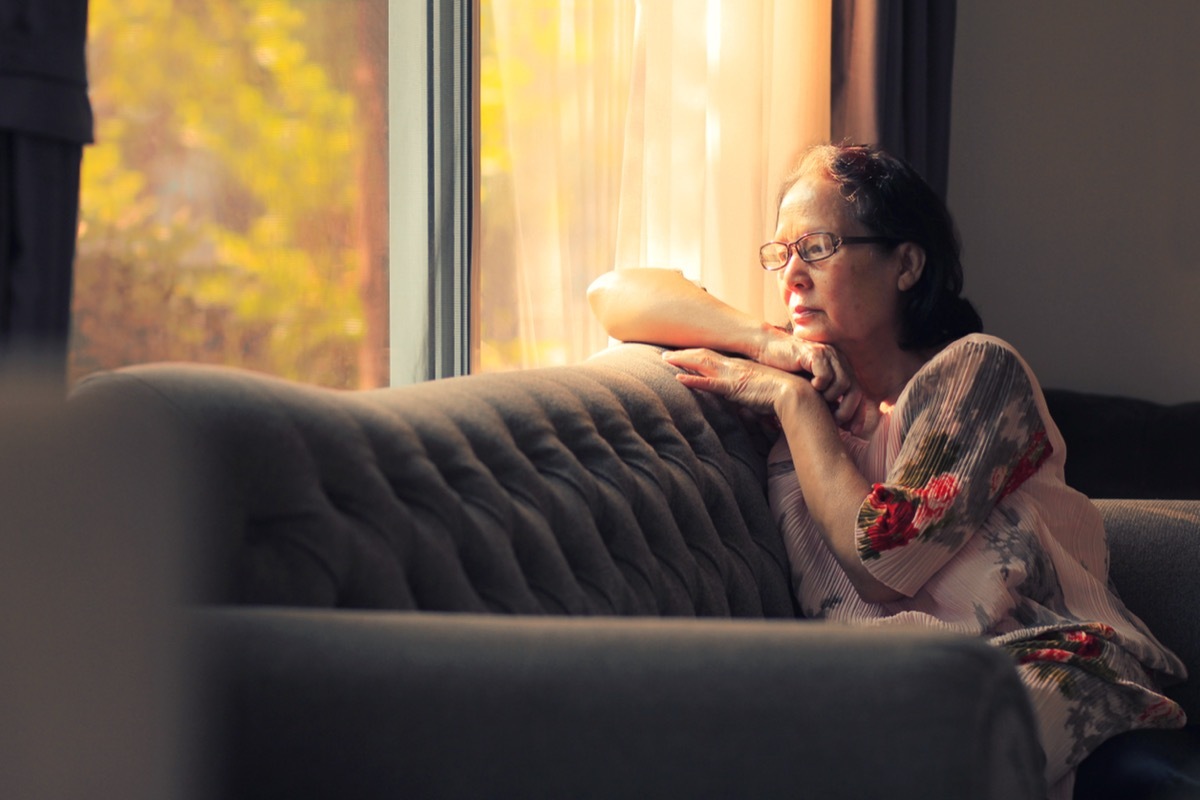 lonely elderly woman on couch