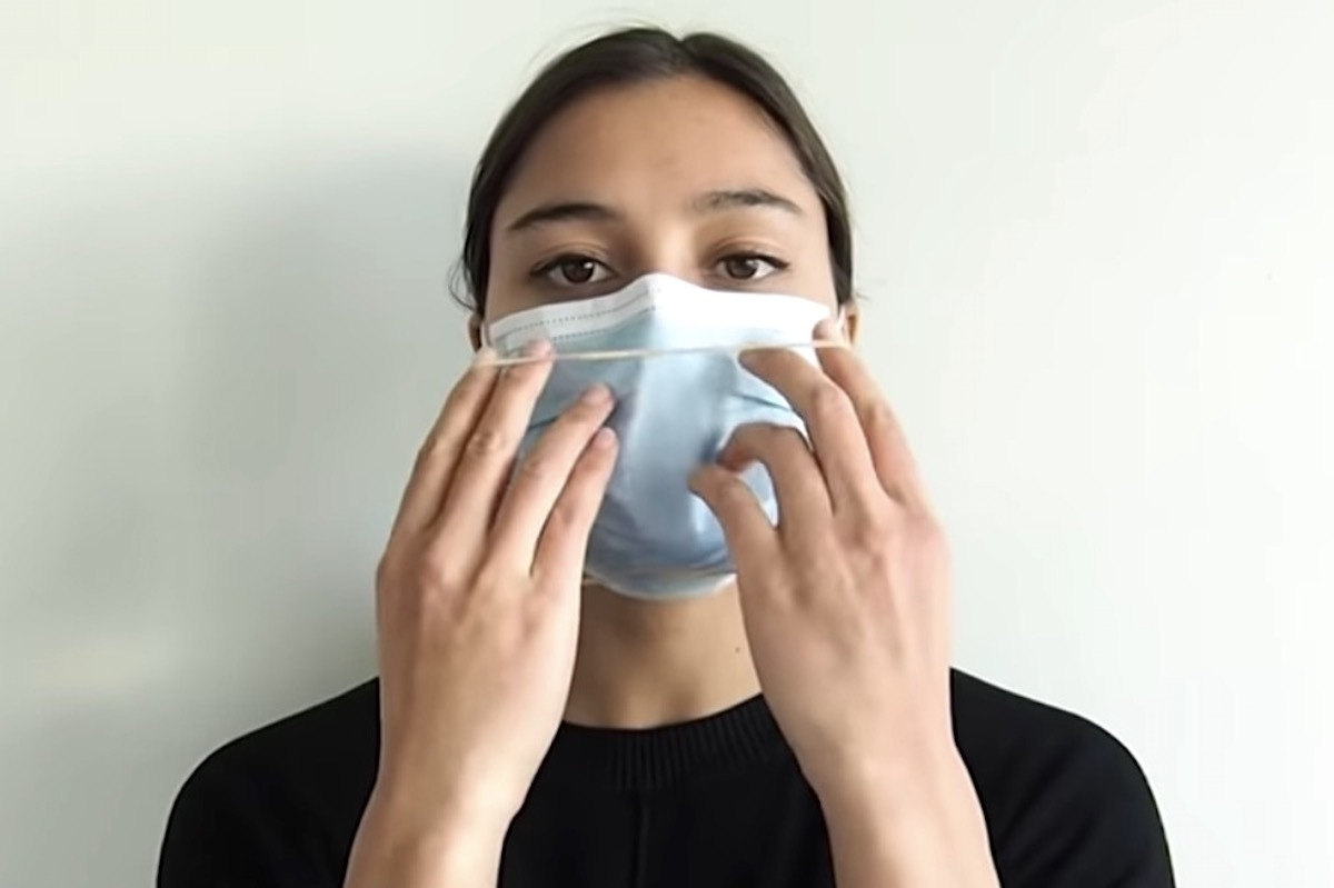 woman putting a mask on her face