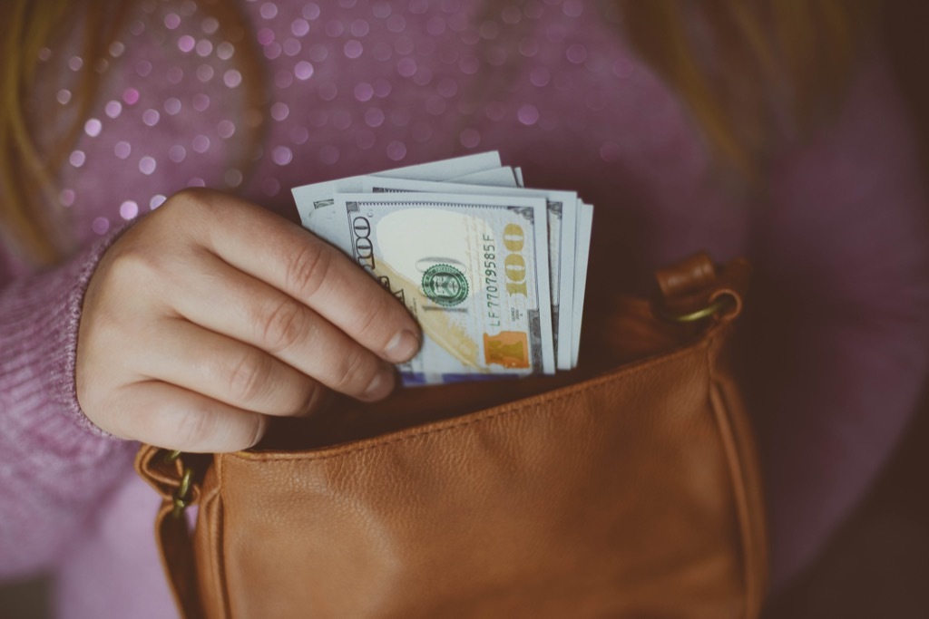 teen holding cash