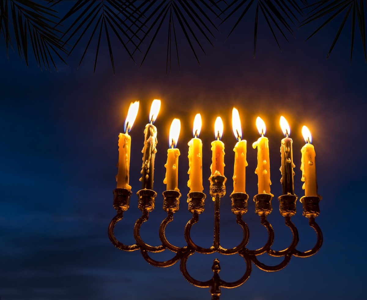 menorah lit outdoors in the dark