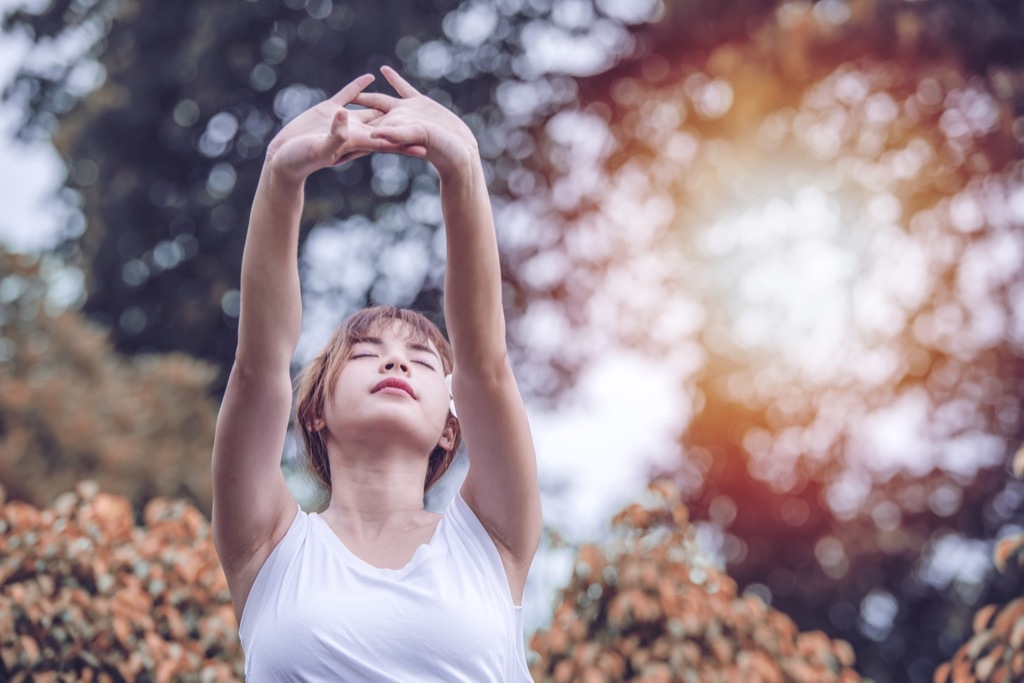 Woman Doing Breathing exercises to fight stress.