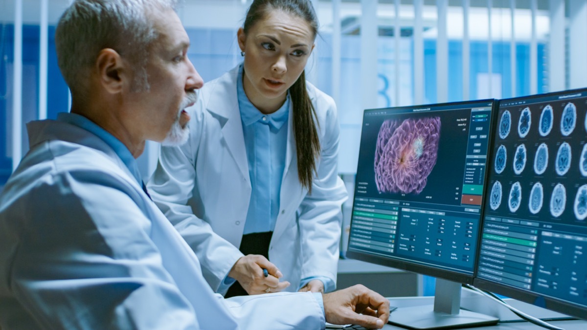 Two Medical Scientists in the Brain Research Laboratory Discussing Progress on the Neurophysiology Project Curing Tumors.