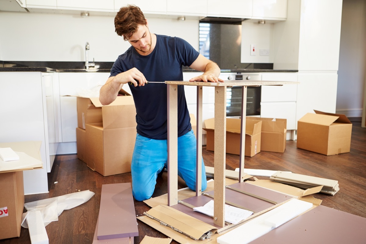 Man building furniture being handy at home