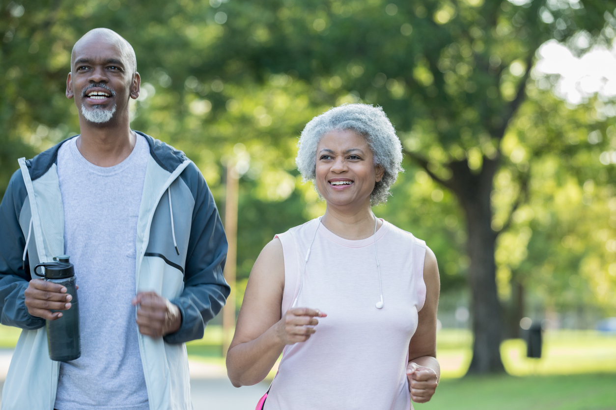 Older couple jogging outside.