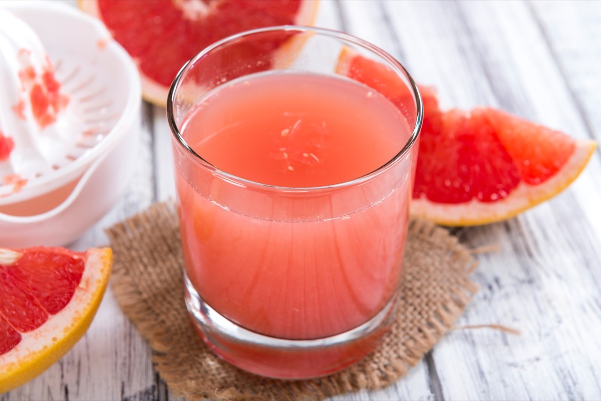 Freshly Squeezed Grapefruit Juice (close-up shot) on vintage wooden background