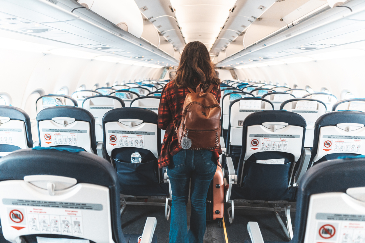 A woman boarding a commercial plane.