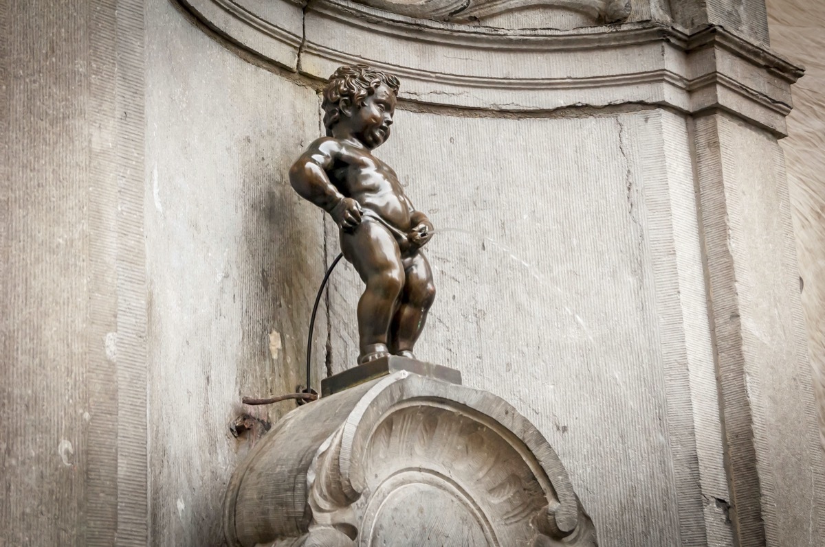 bronze statue of little man peeing