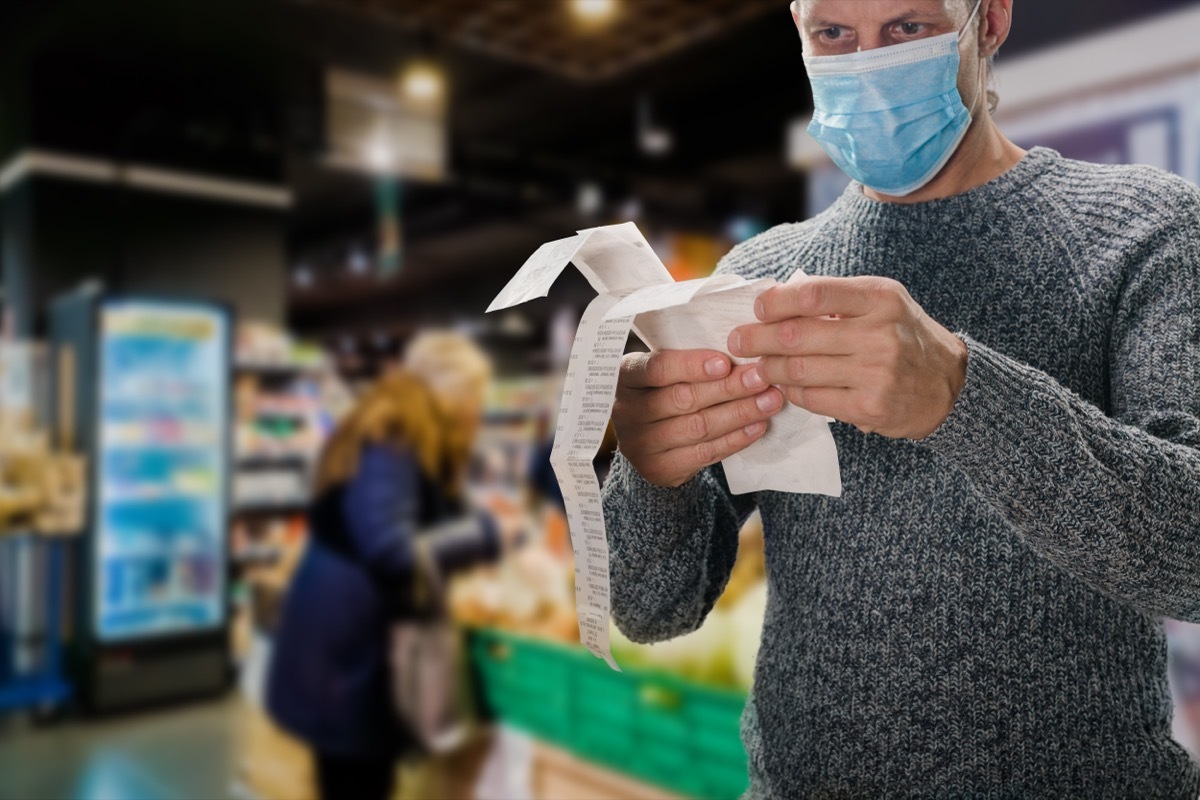 Man checking receipt at supermarket