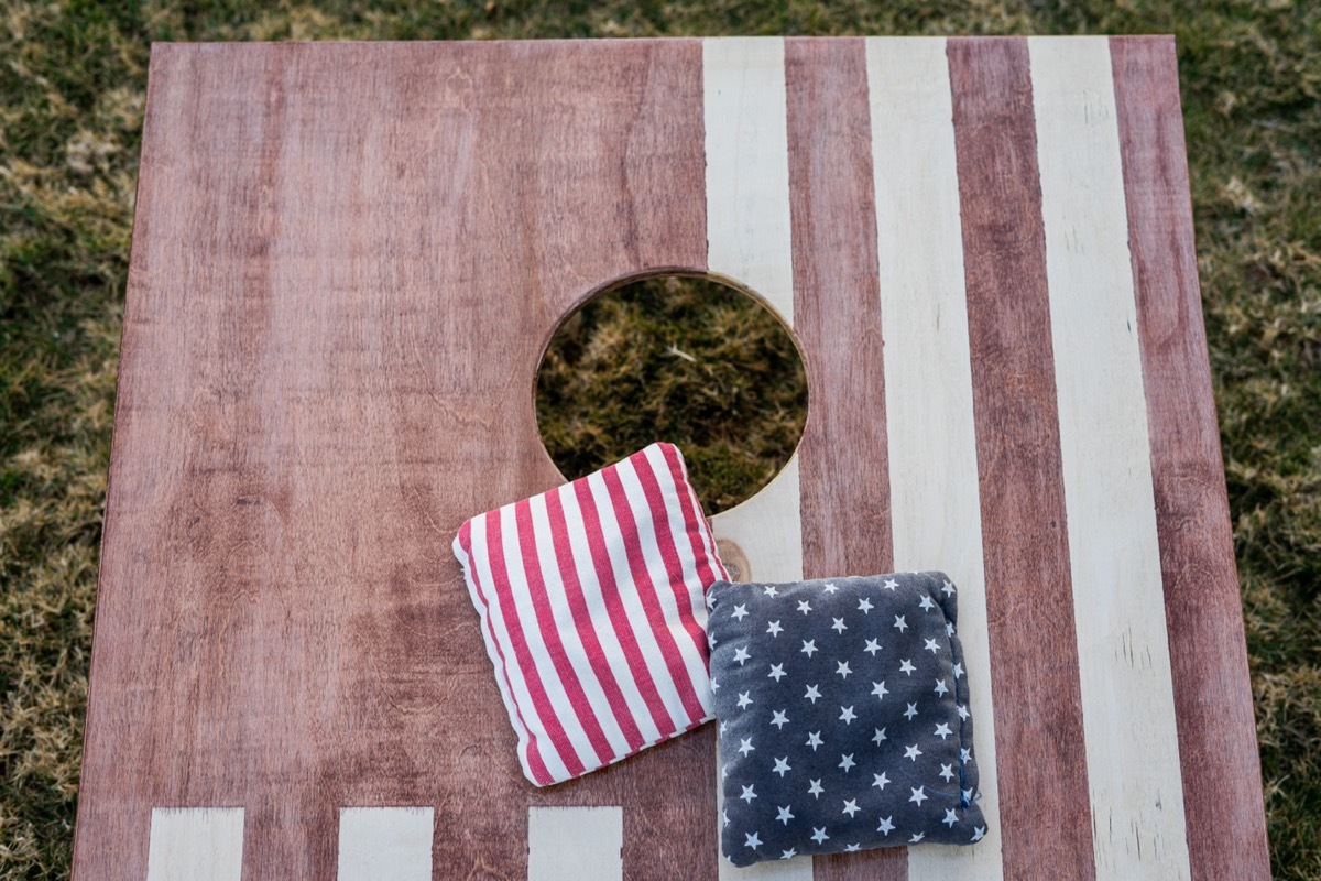 Bean bags on American flag Cornhole board