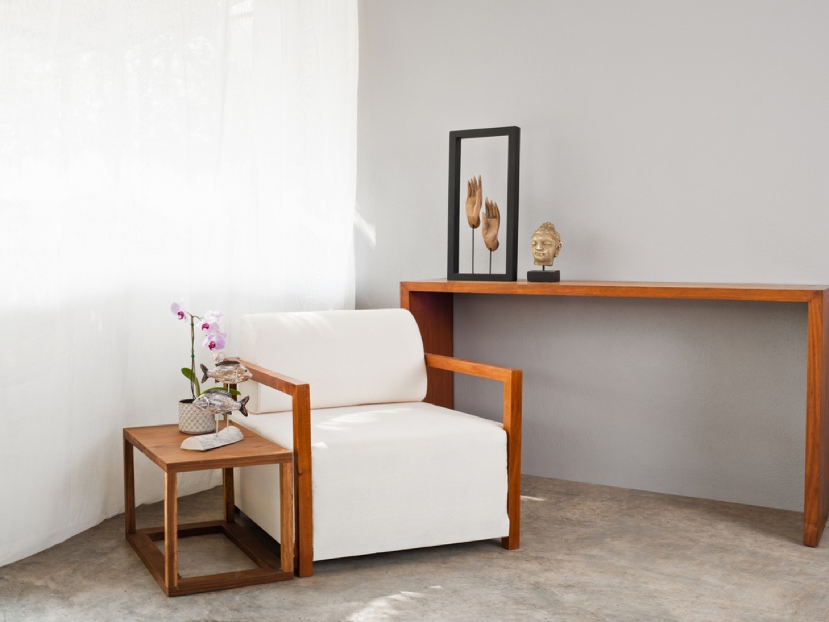 modern home with wood tables and white chair with wooden arms