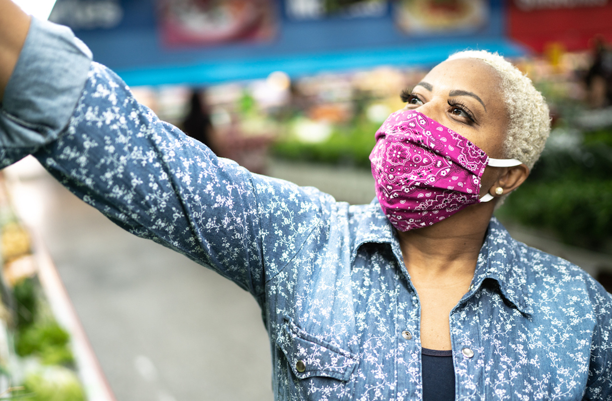 Woman with face mask shopping at supermarket