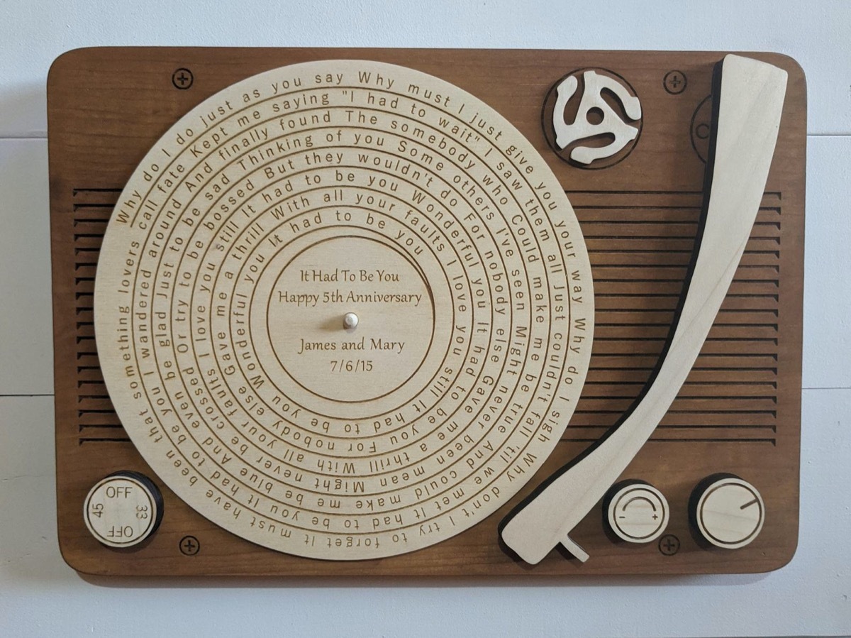 wooden record player engraved with song lyrics