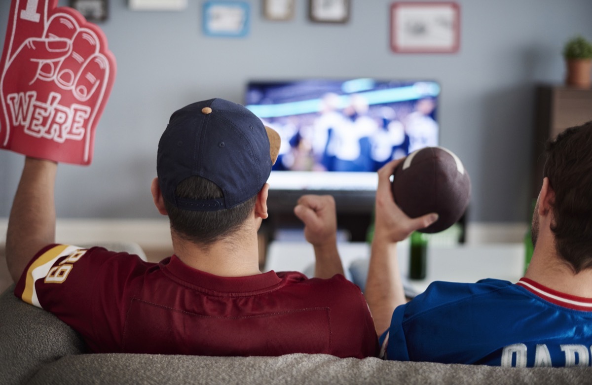 Two men watching the Super Bowl on TV