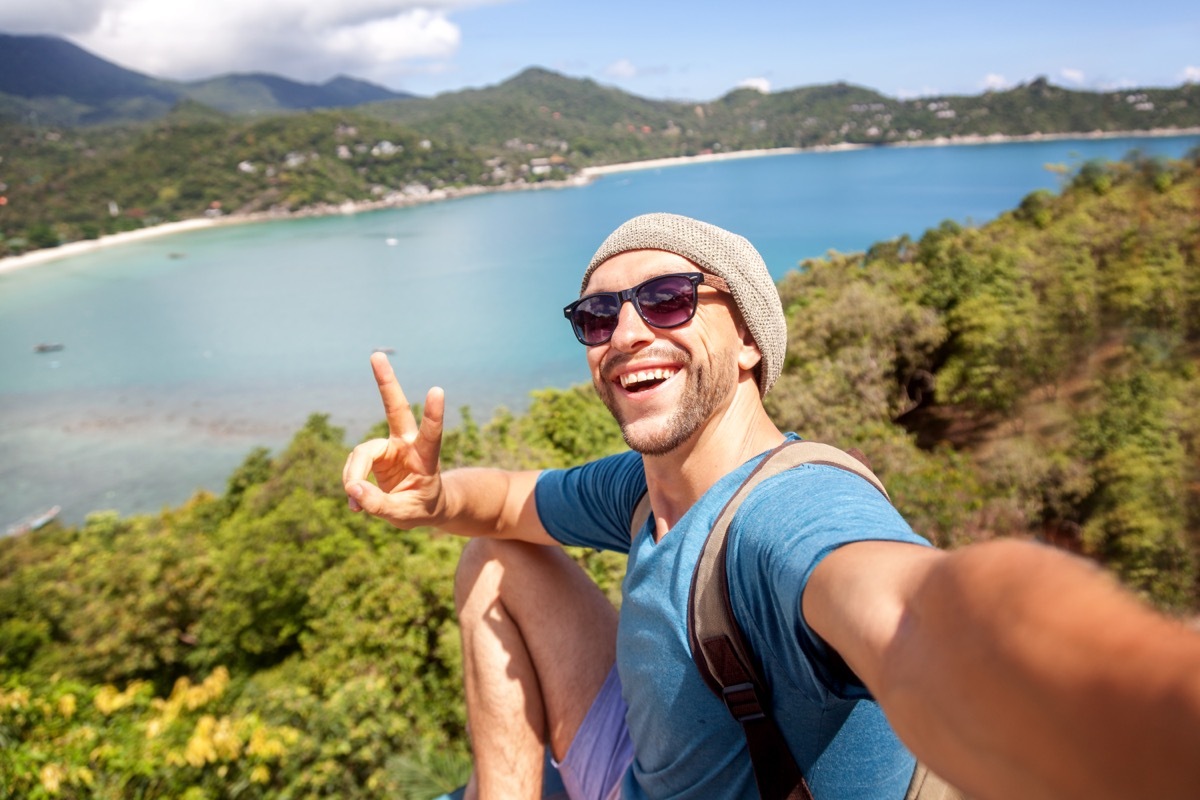 Adventurous Man Holding Up a Peace Sign