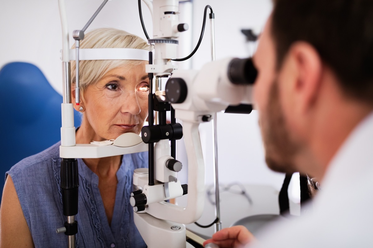 woman gets checked by a male eye doctor