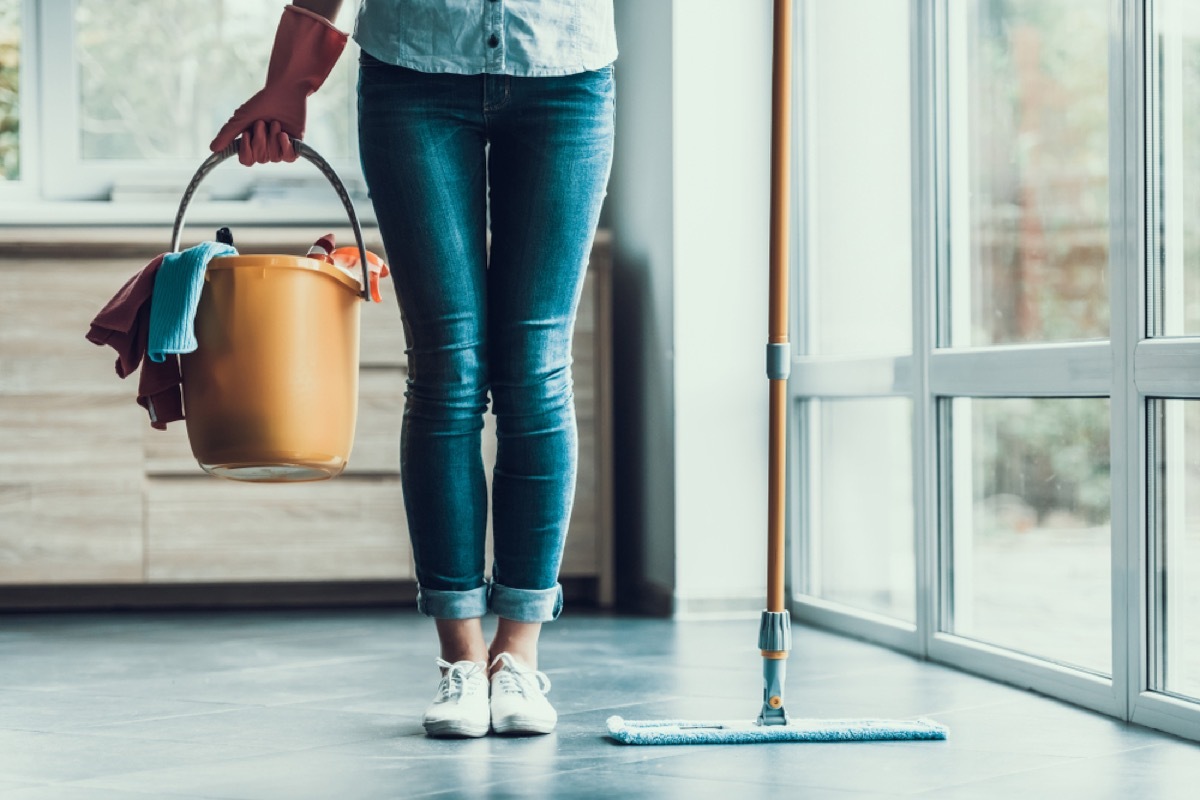 woman holding cleaning bucket, essential home supplies