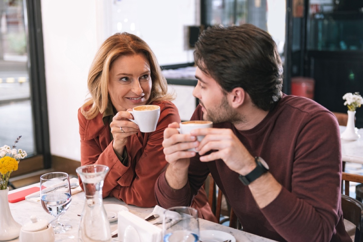 middle aged white woman having coffee with a younger white man