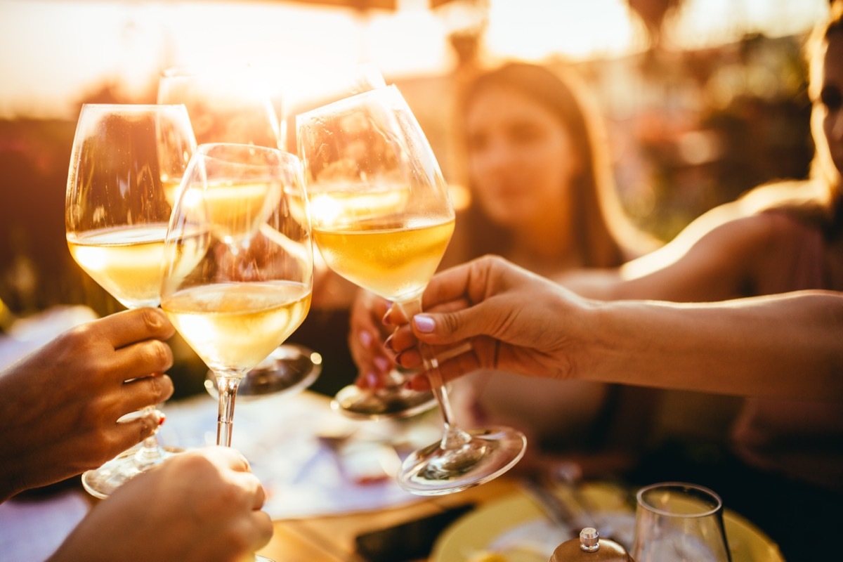 people clinking glasses at a wine tasting