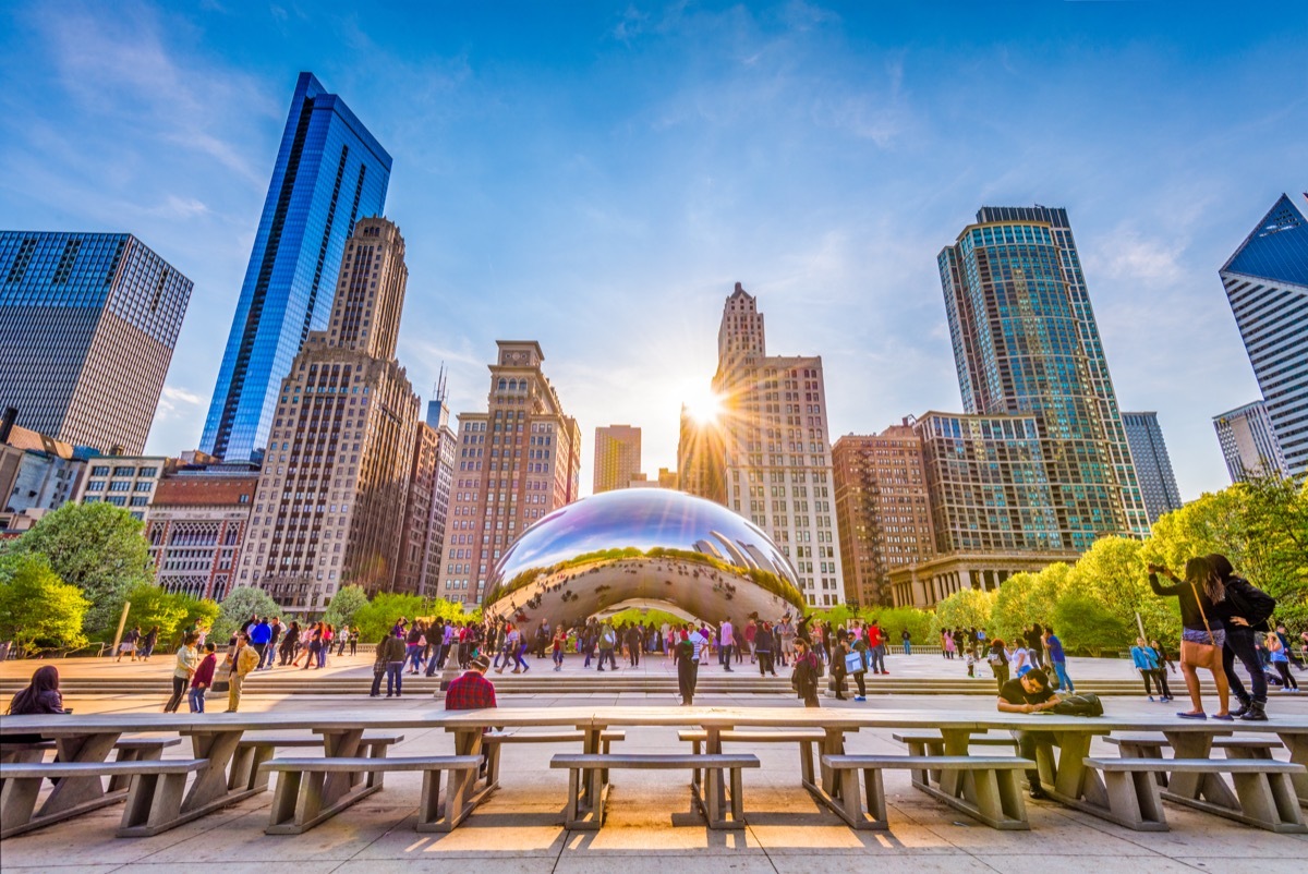 Tourists visit Cloud Gate in Millennium Park in the late afternoon.