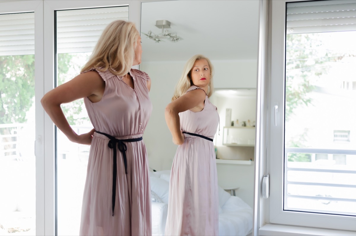 Woman looking at herself in the mirror