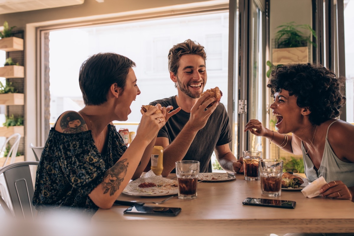 Friends laughing and eating