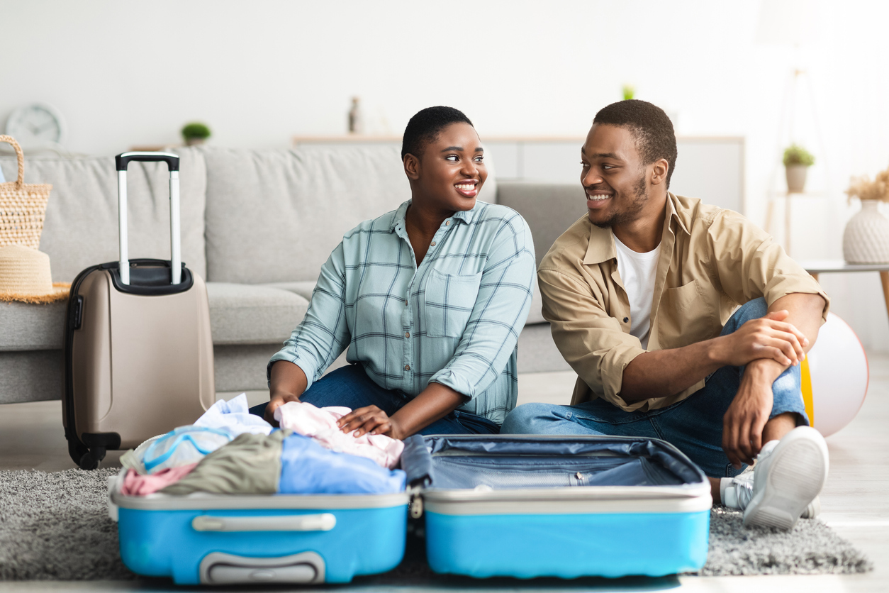 A couple packing their suitcases for a trip