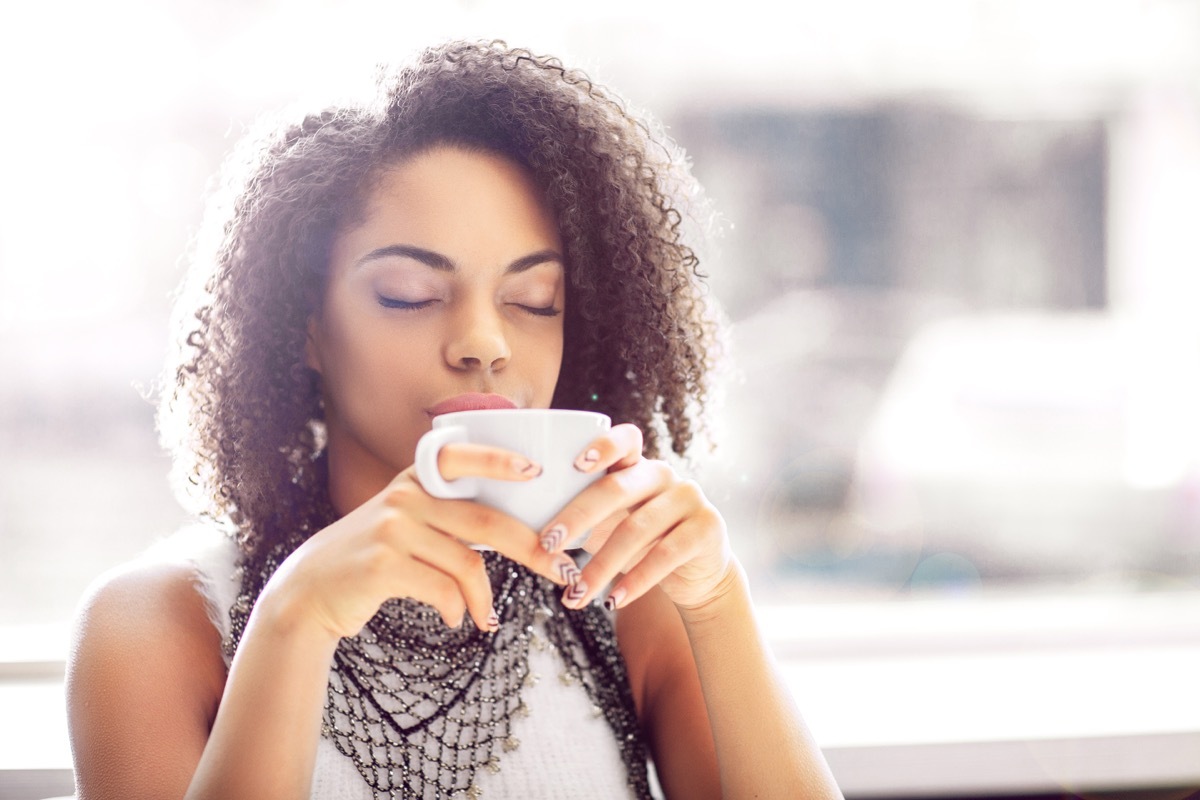 woman holding coffee cup