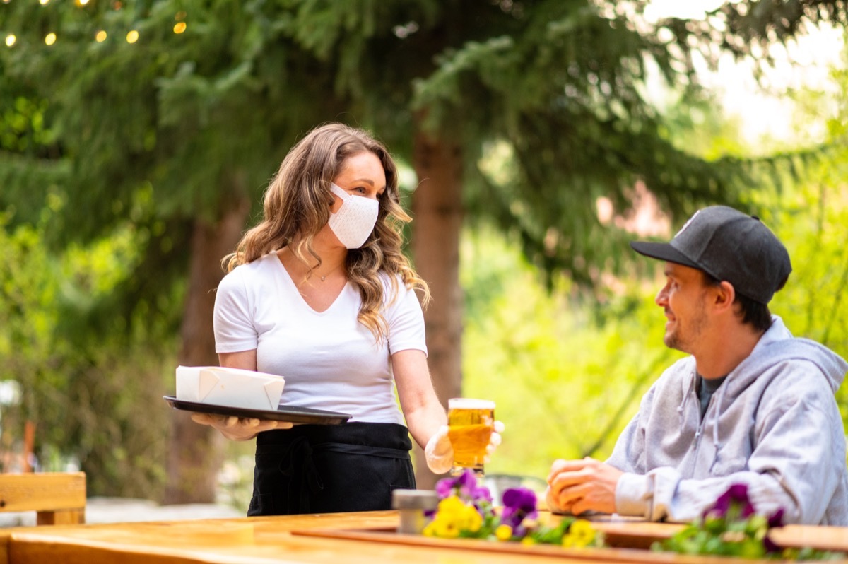 Server wearing a face mask to prevent the spread of COVID-19