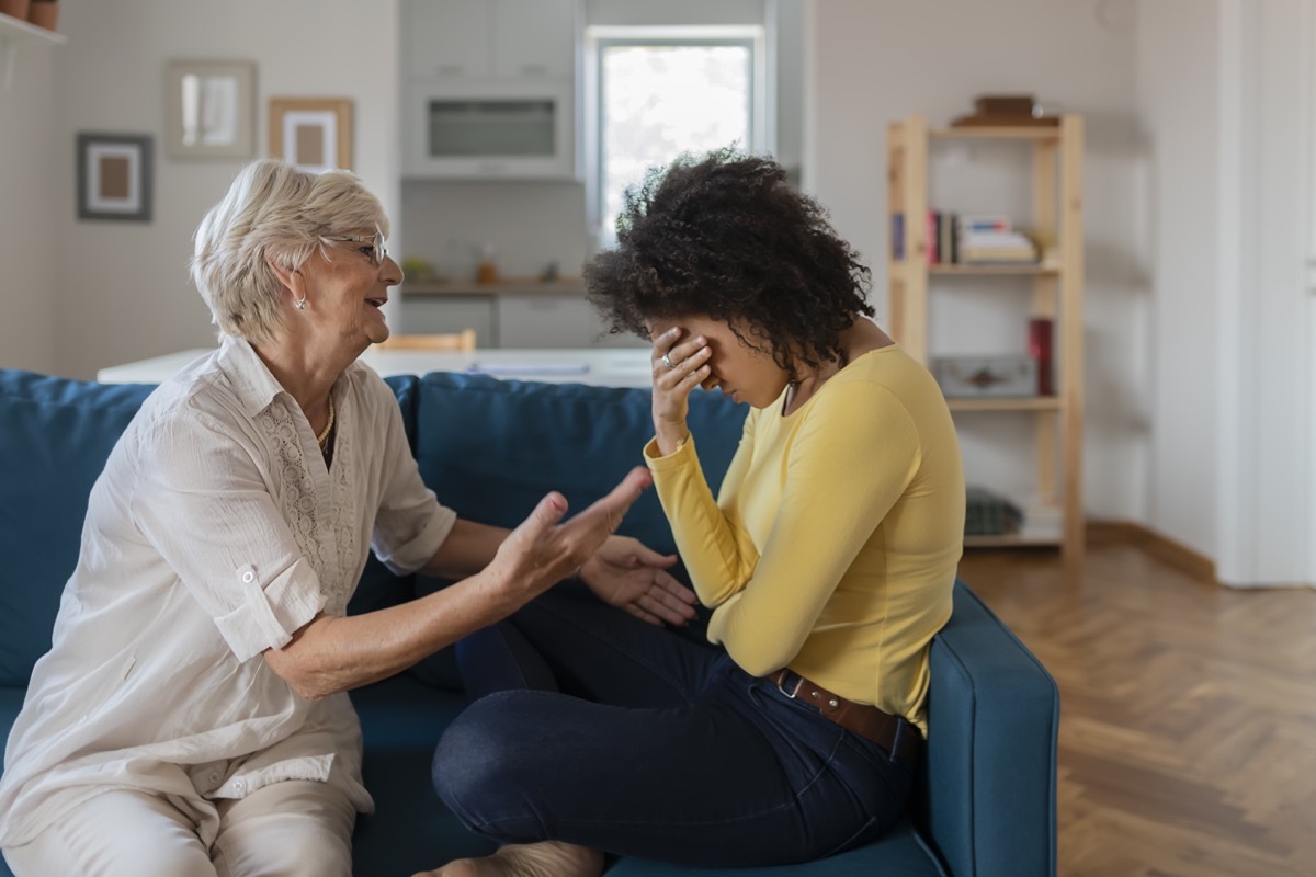 Loving Worried Older Mother Comforting Sad Adult Adopted Mixed Race Grown Daughter. Understanding Senior Mum Consoling Crying Young Woman Being Friend Helping With Problem, Care, Empathy Support in Two Age Generations. Worried Aged Mother Embracing Comforting Grown Up Mixed Race Daughter With Broken Heart Family Sit on Sofa, Elderly Mom Soothe Crying Adult Child, Divorce or Miscarriage, Share Problem With Someone Close Concept