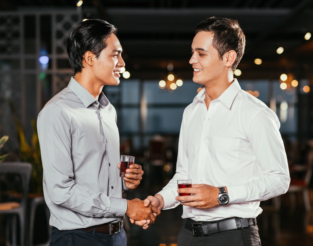 Men Shaking Hands at Bar smiling