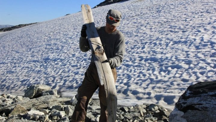 a piece of wood being held up by a man