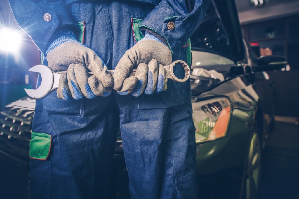 car mechanic holding wrench {stereotypes}