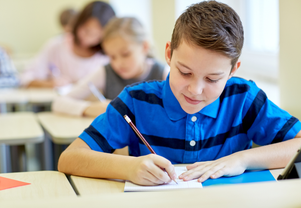 Kid Writing in Class 6th Grade English