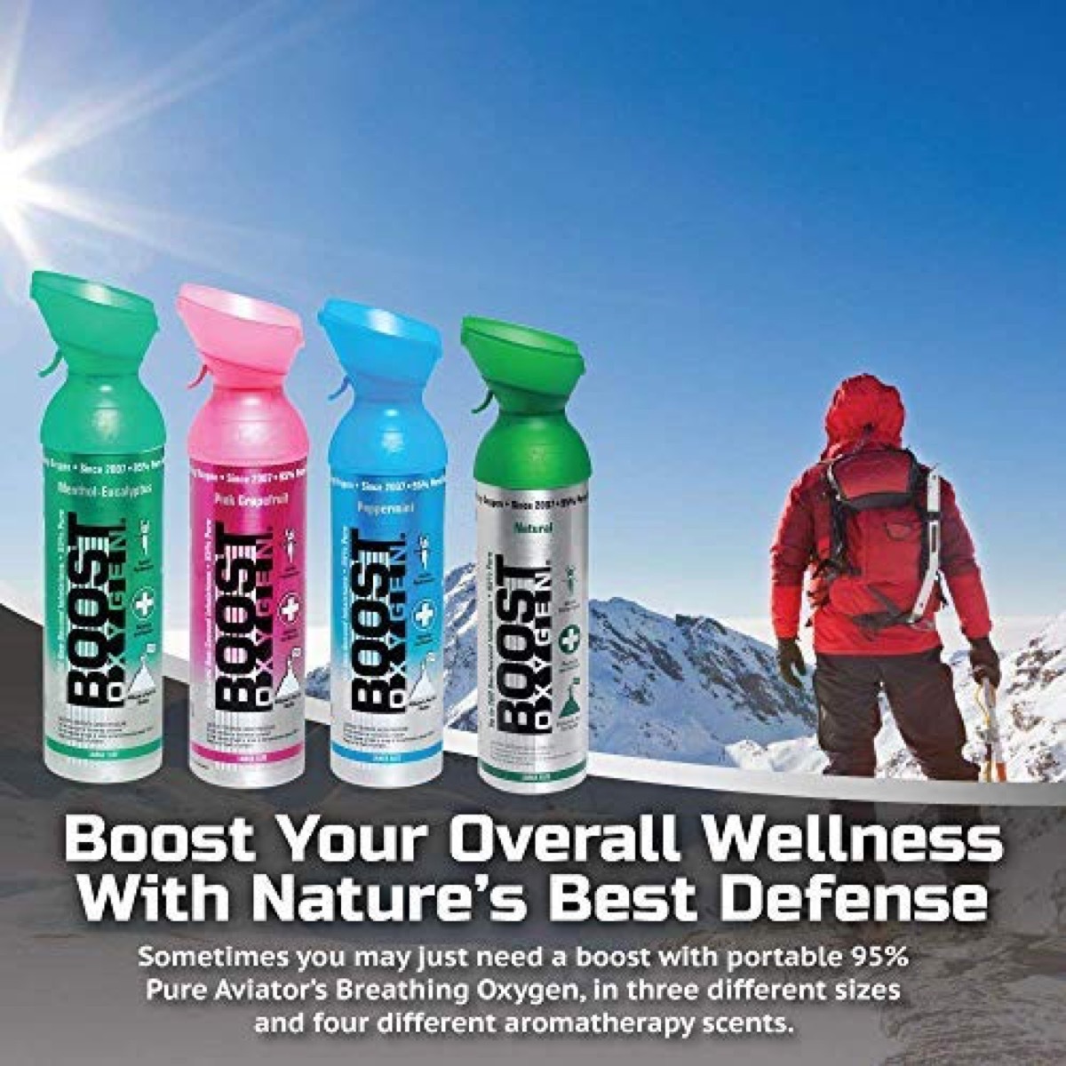 man in red jacket on mountaintop and four bottles of boost oxygen