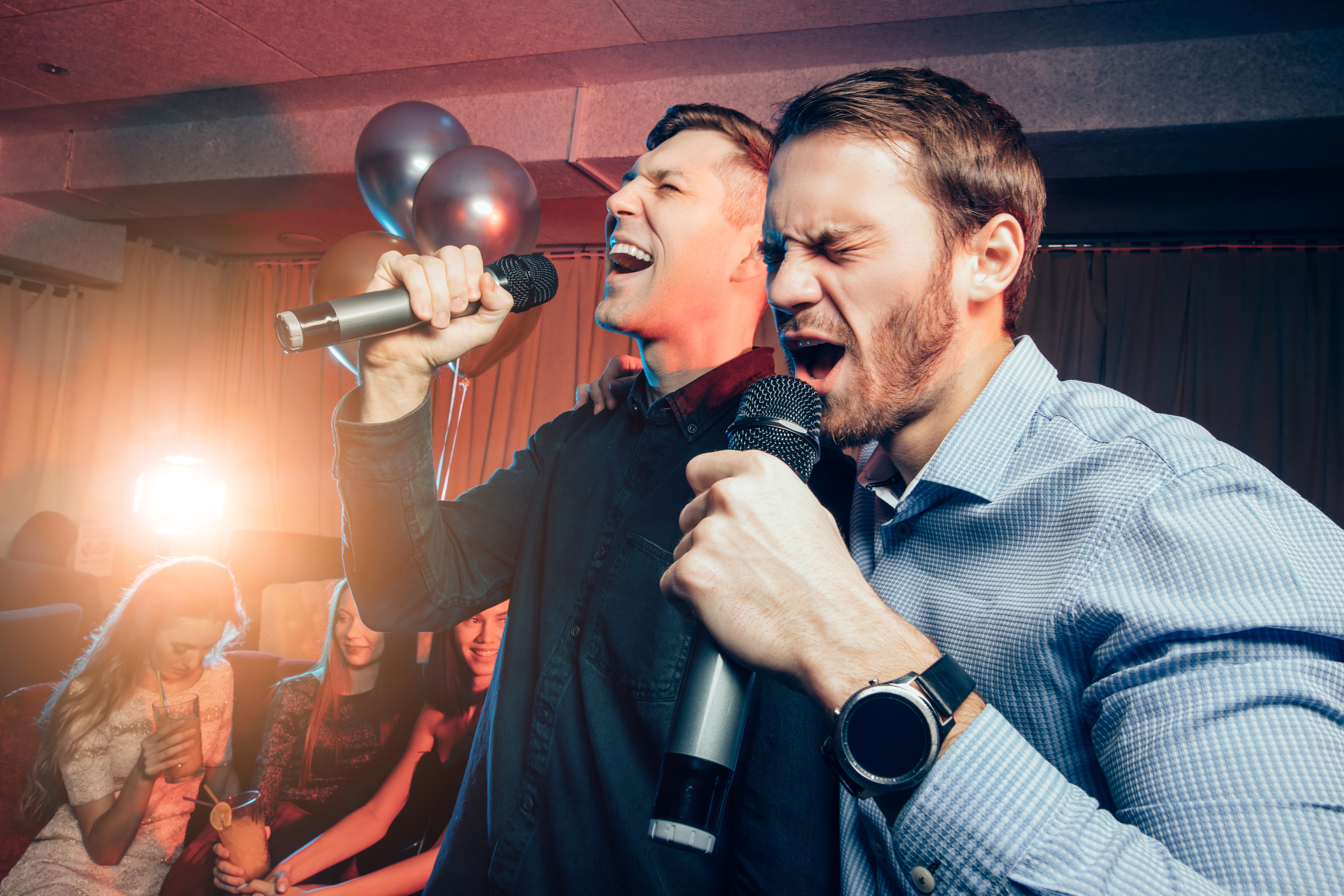 men singing karaoke