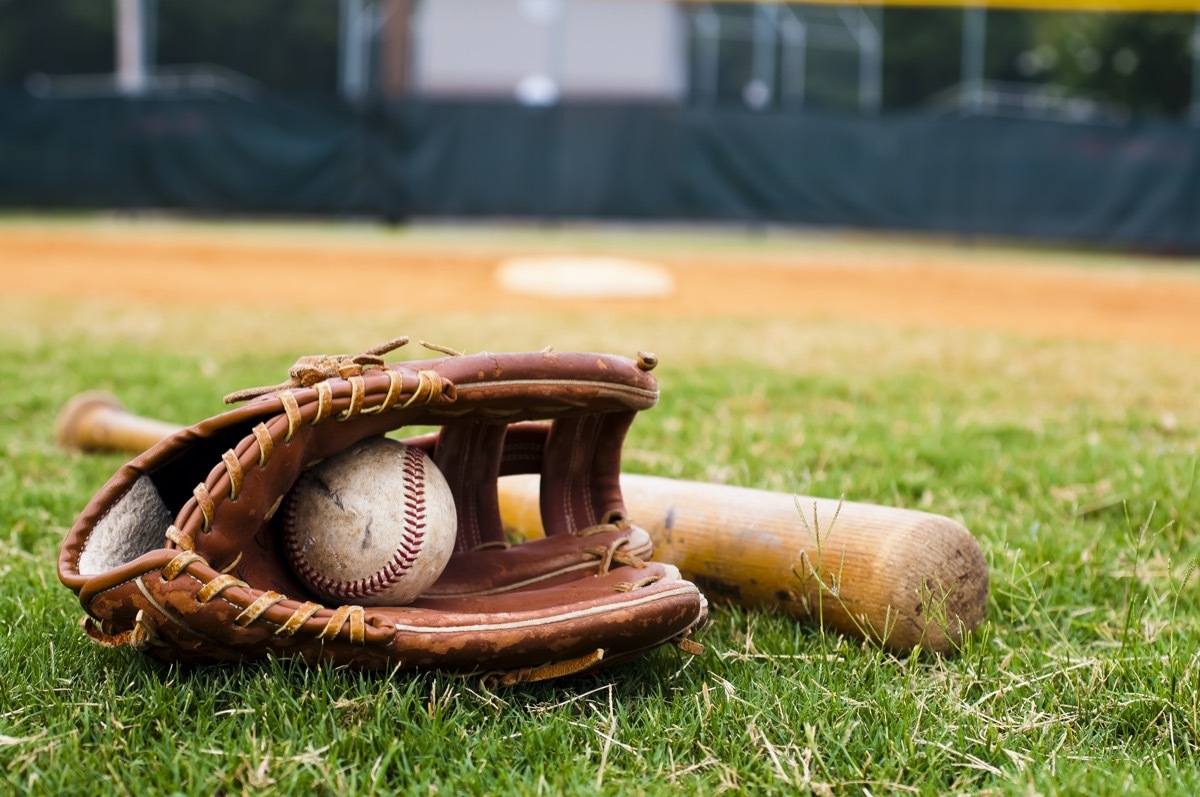 baseball bat and glove and ball on grass