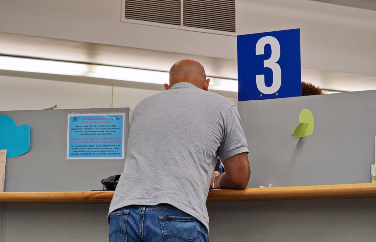 A man consults a customer service agent at the third booth