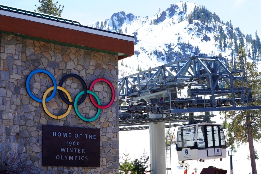 A lift and the base lodge of Palisaides Tahoe ski resort with the Olympic Rings