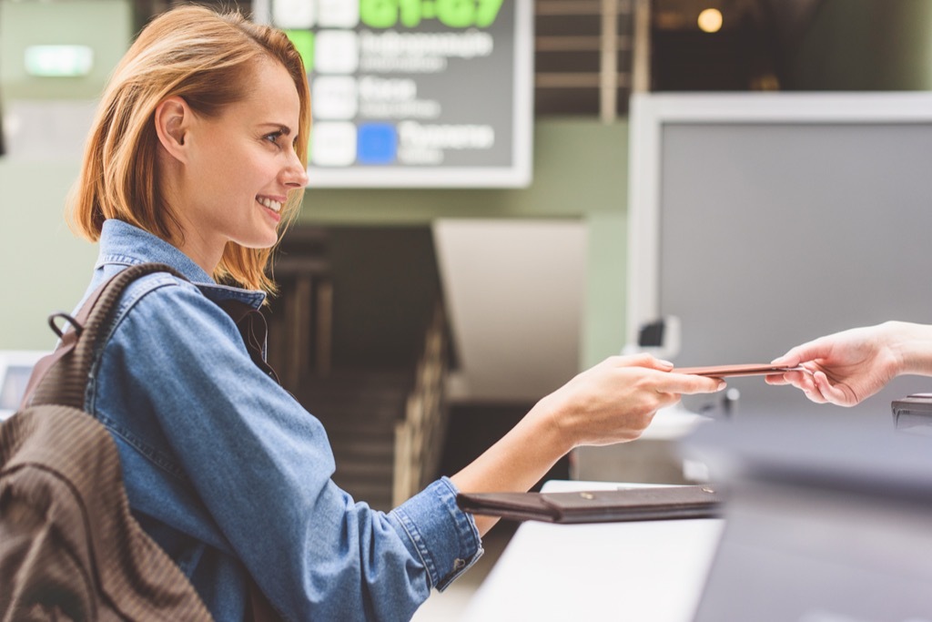 woman at airport getting cheap airfare