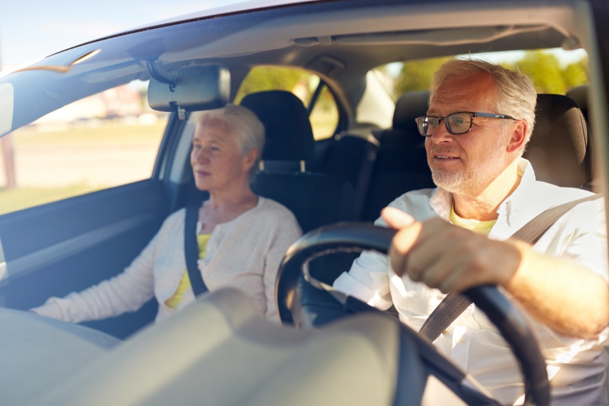 Senior couple driving in car.