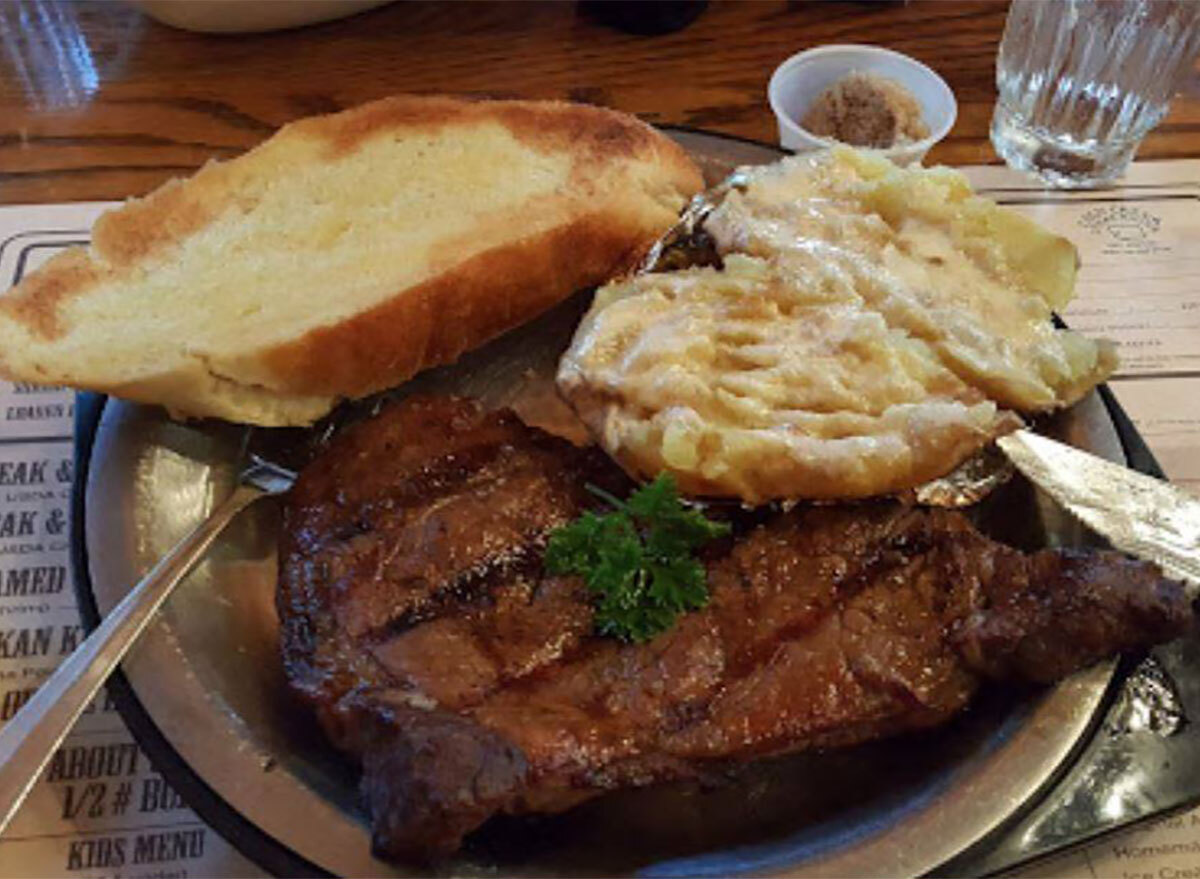 plated steak with bread and mashed potatoes