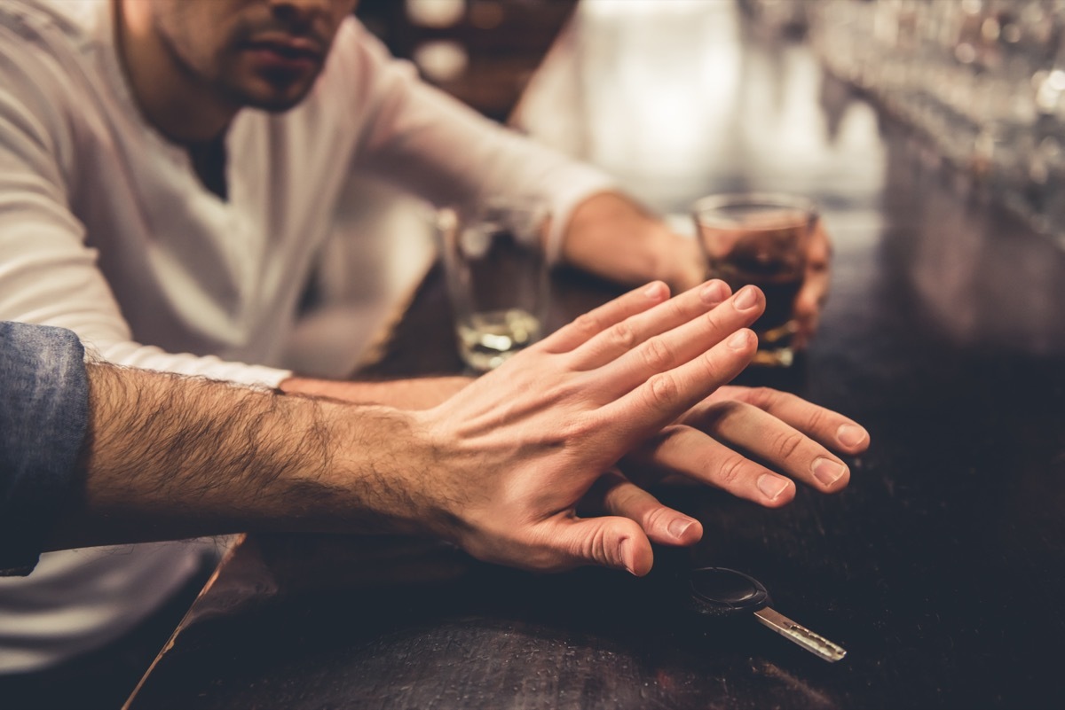 Friend telling his friend to stop drinking. 