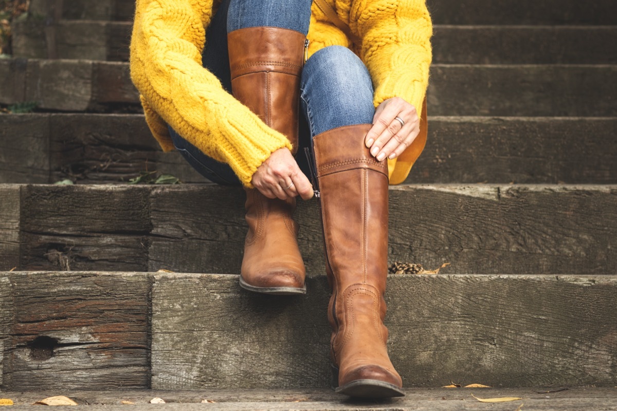 Woman Zipping up Riding Boots