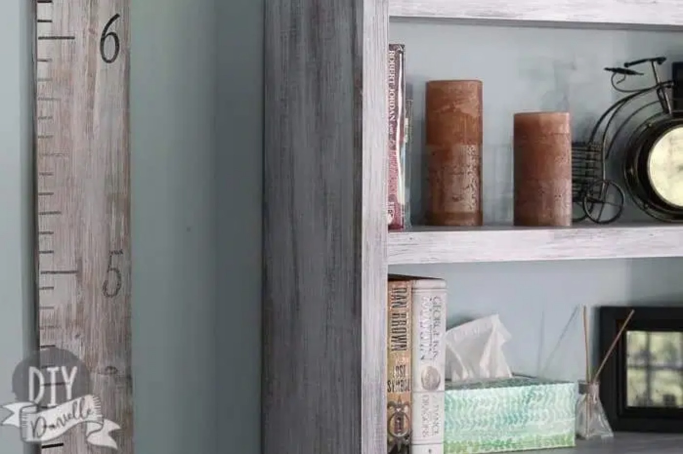 gray bookshelf with candles and books