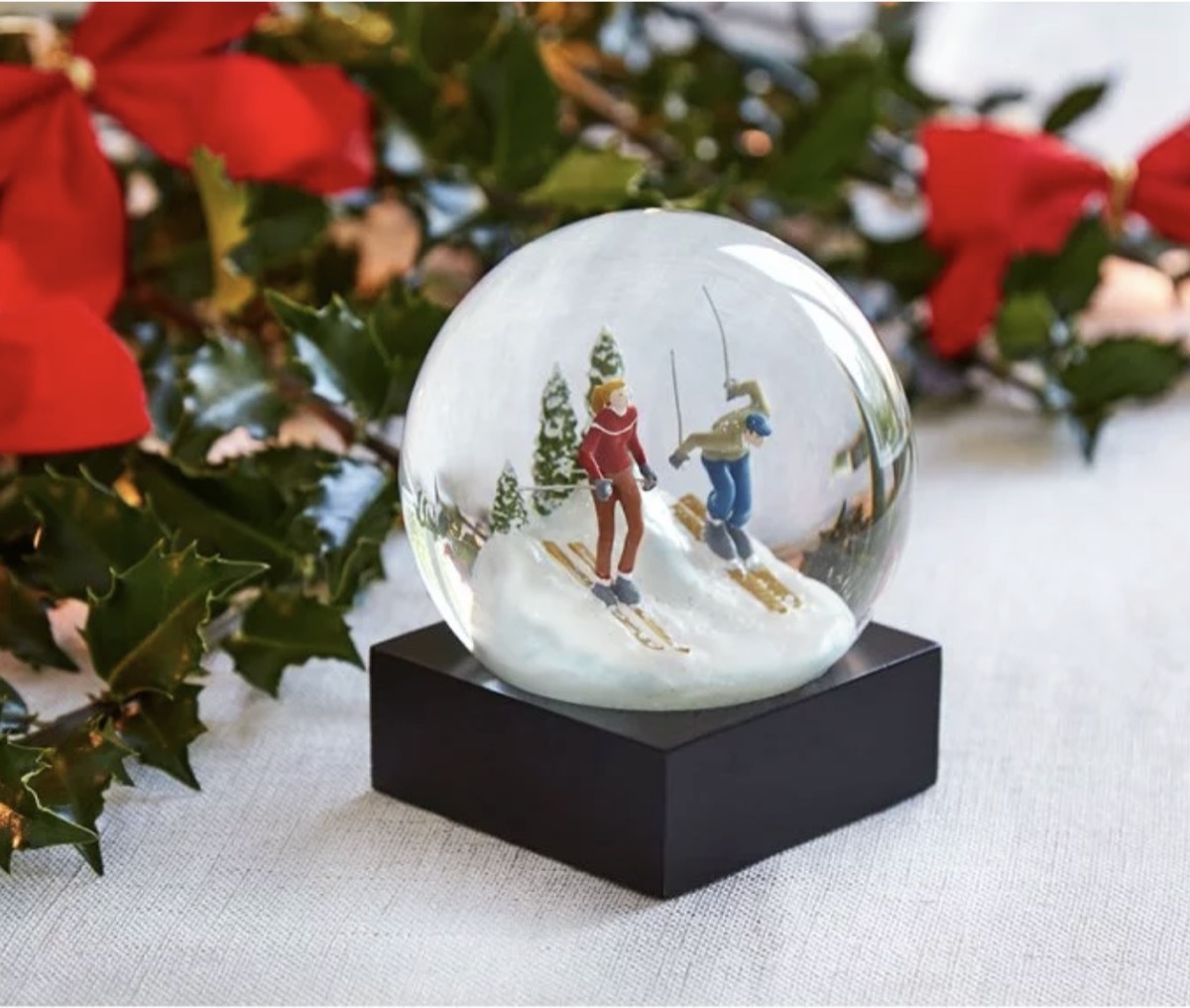 modern snow globe with skiing figures inside