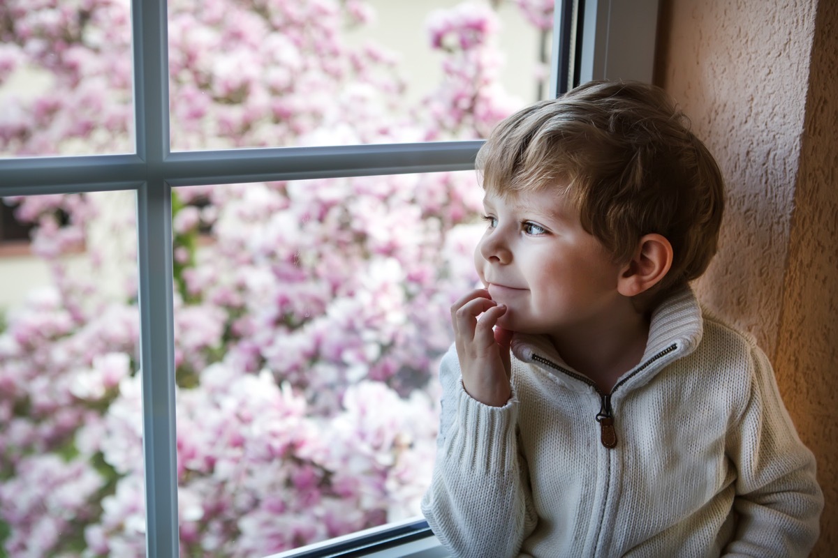 little white boy looking out window