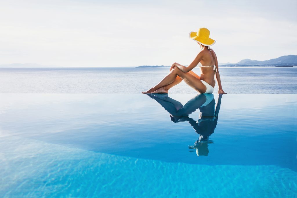 woman infinity pool vacation