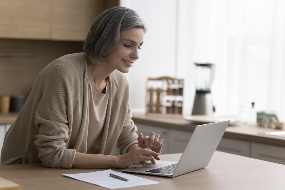 woman over 50 using laptop